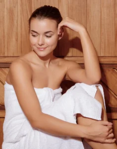 Relaxing woman in a towel after a detox body wrap session